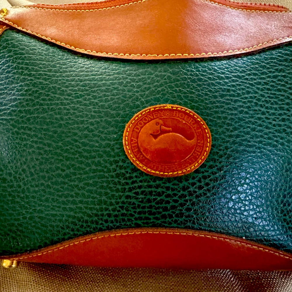 Beautiful forest green Dooney and Brooke purse with shoulder strap.